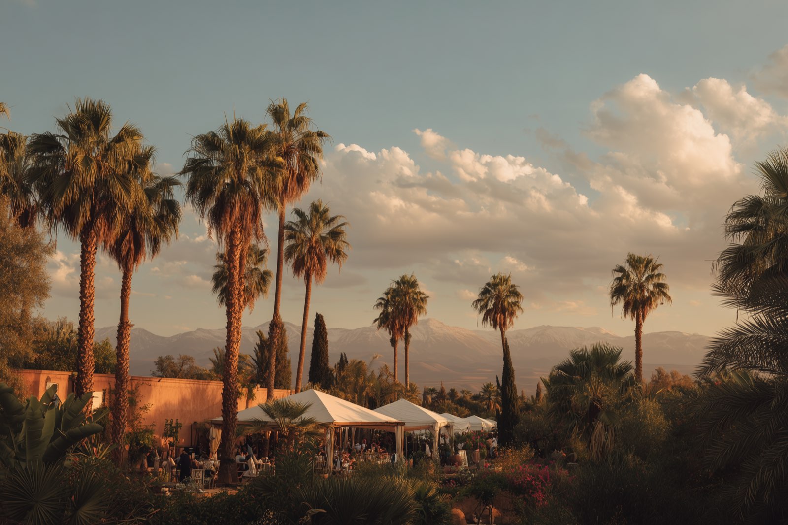 An event set up in the gardens of a Marrakech property, the Atlas mountains behind